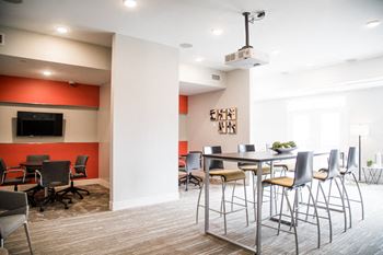 a conference room with a table and chairs and a tv at The Foundry, South Bend Indiana